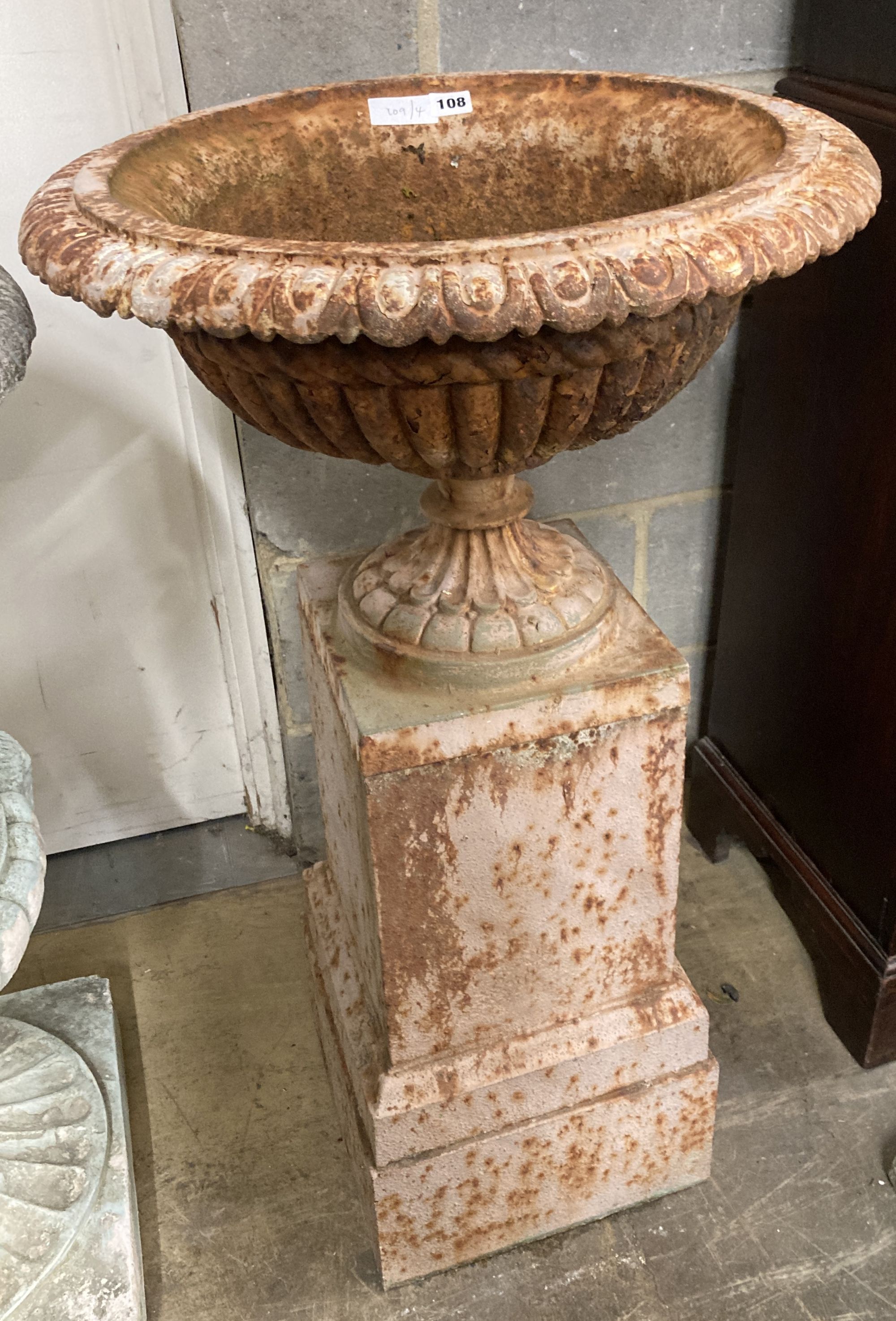 A Victorian style cast iron campana garden urn on stand, diameter 52cm, height 97cm